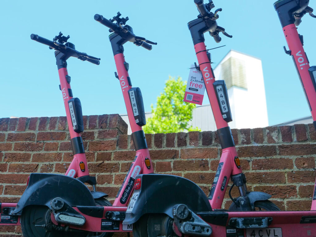 Wolfson's electric scooters standing at the front of the College.