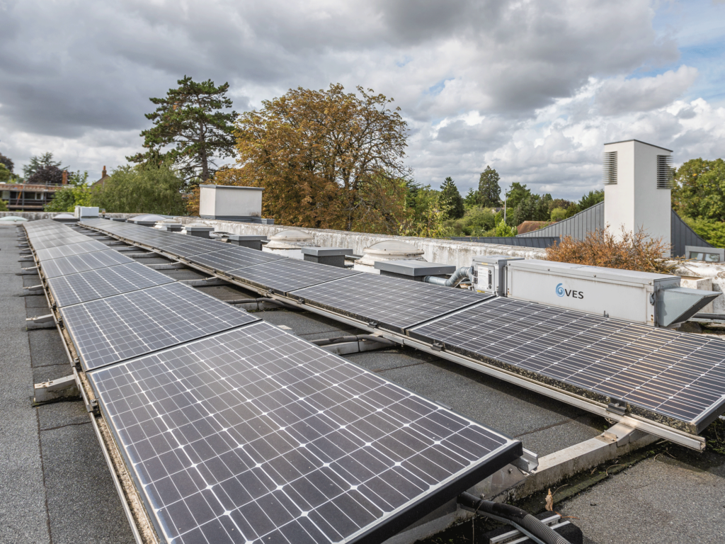 Solar panels on the roof of A Block, with the tower in the background.